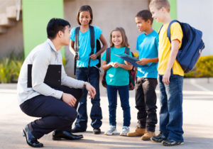 A young man talks to students