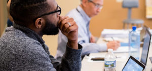 Doctoral students listening to a lecture.