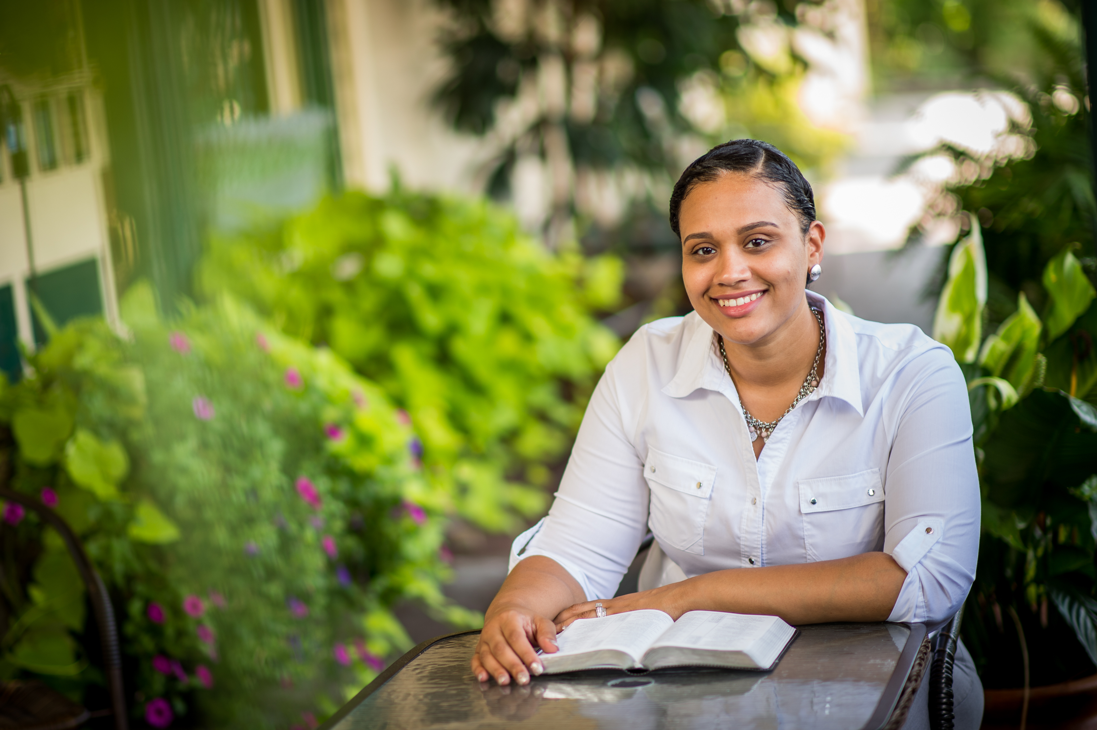 A female online student, Nathali Santiago pauses from her study of the Bible to pose for a picture.