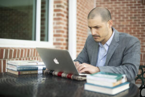 A man working on a laptop. 