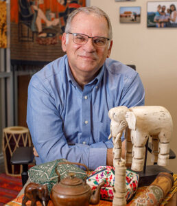 Dr. Ed Scheuerman, here in his Intercultural Studies office, is seen walking to and around campus regularly--sometimes barefoot. 