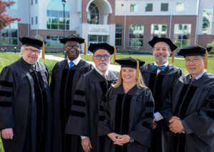 Doctoral graduates gather on LBC's main campus at graduation 2023.