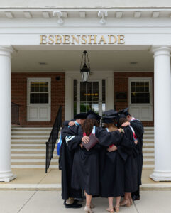 students praying together at graduation