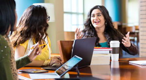 women at table working in ministry
