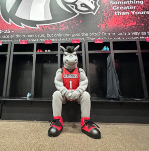 LBC charger mascot, bolt, sitting in locker room.