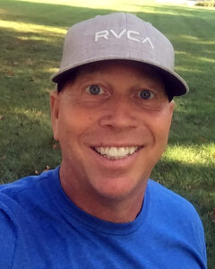 headshot of brady rennix in blue shirt