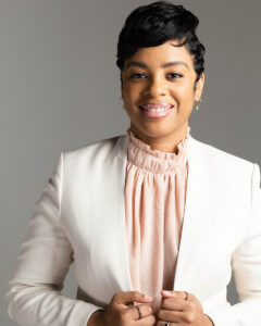 headshot of Ryan Killebrew in pink blouse and white blazer