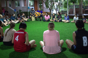 The Thailand team interacts with a volleyball team. 