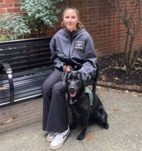 LBC Health & Physical Education major and field hockey player Ellie Bollinger (’28), pictured here with Daz, has trained six seeing eye dogs with her family since the age of 10.