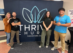 From left, Brittney (Becker ’12) Boosz, BJ Boosz (’11 & ’12), Rebekah LeCates ('23) and Sam Edwards ('25) serve together at Thrive Church in York, Pa.