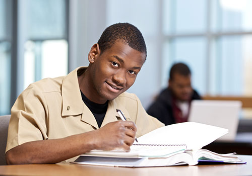 A student writing in a notebook.