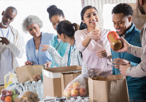 A student helps with food distribution