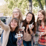 Cheerful students taking a selfie at homecoming.