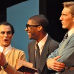 Three students performing in a play.