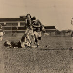 The 1972 soccer team plays on a field located next to the current student union building.