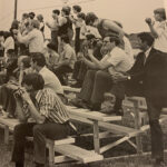 A crowd of fans cheers on the Chargers during a soccer game in 1973. The gentleman on the right of the photo with his hands around his knees is longtime employee Gilbert Gregory, and above him is his son, then-teenager Gordon Gregory—today Dr. Gordon Gregory of the Bible & Theology Department.