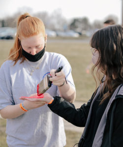 Students painting on the Spirit Rock