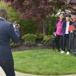 A graduate and his family posing for a portrait.