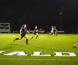 Female athletes playing soccer.