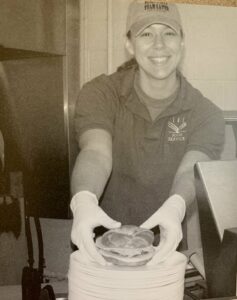 A student worker serves a sandwich at Olewine Dining Commons during the 2005-06 academic year.