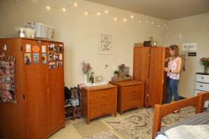 A student organizing her dorm room.