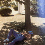 Like all college students have to do at least once in their collegiate lifetime, this student in 1981 is taking a nap under a tree by Esbenshade Hall.