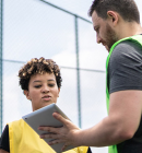 coach with player reviewing the play