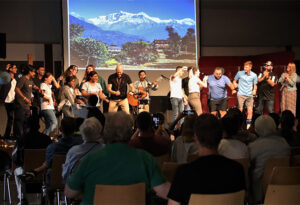 Students and staff join in a traditional Nepali dance on stage at the Christian Endeavor World Convention.