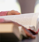 hands with an open Bible